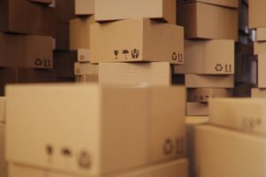Piles of brown cardboard boxes stacked messily in a pile